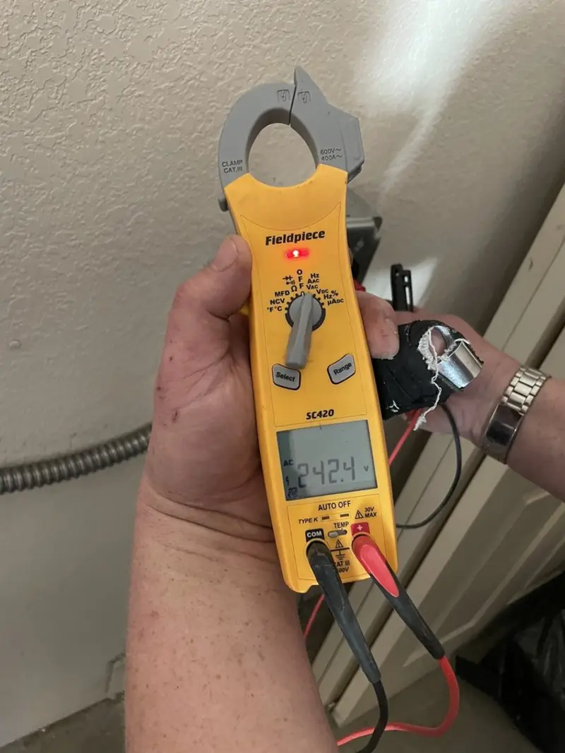 Voltage testing with clamp meter during Ceiling Fan Installation in Orange